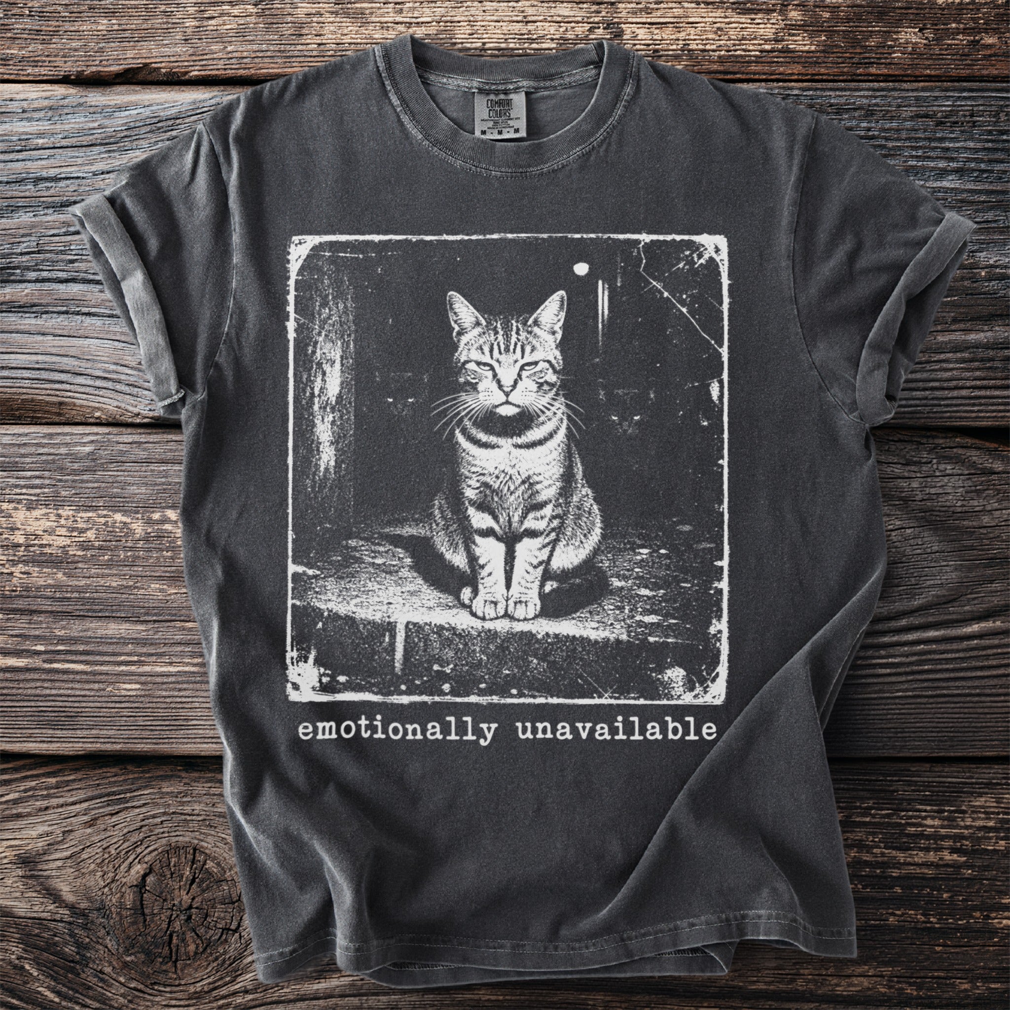 T-shirt with a black and white print of a cat and the text "emotionally unavailable".