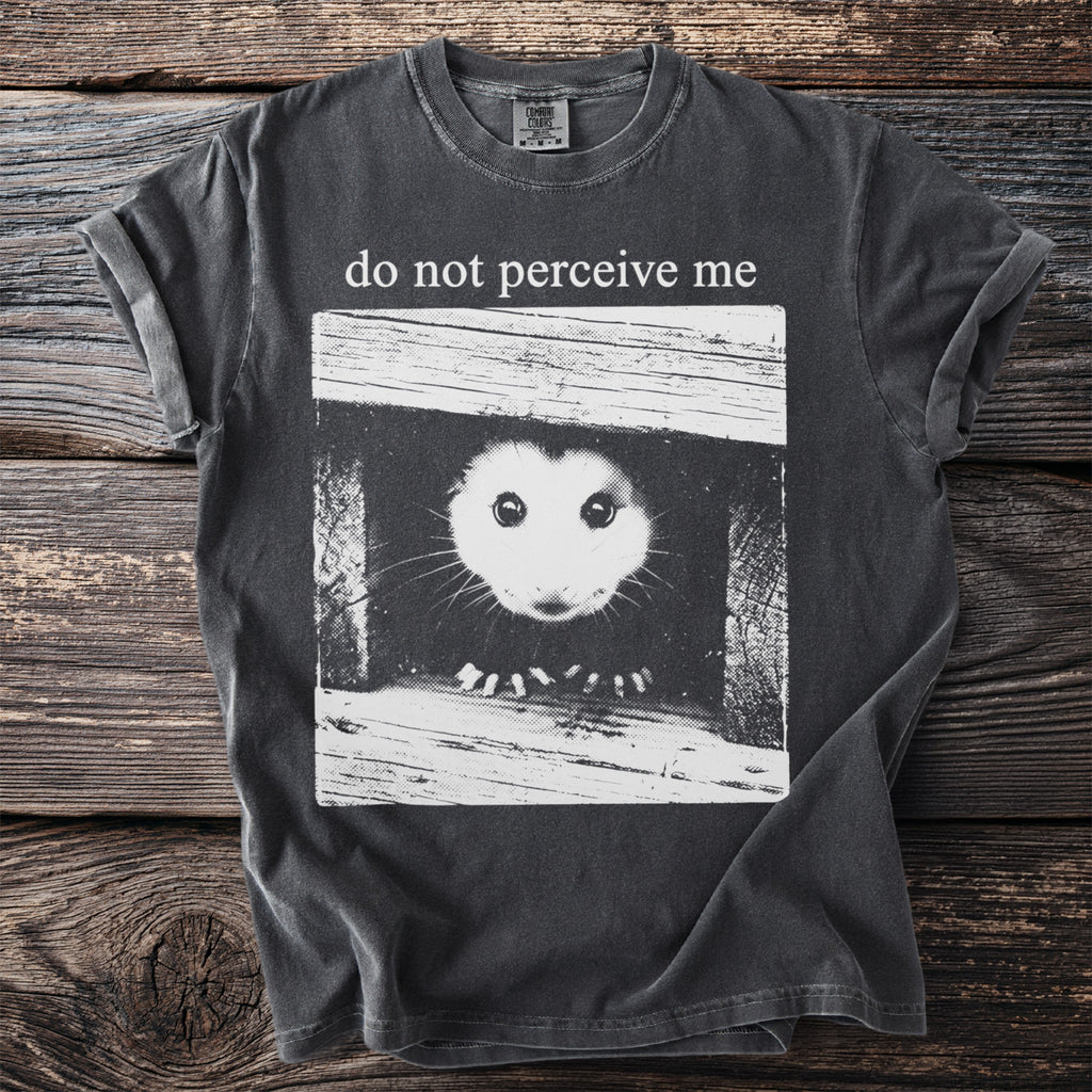 Dark gray t-shirt with "do not perceive me" and a possum peeking out of a box.