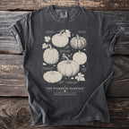 T-shirt graphic featuring "The Pumpkin Harvest" title with illustrated heirloom pumpkin varieties.