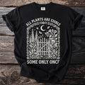 Black t-shirt with "All Plants Are Edible Some Only Once" text and botanical skull design.