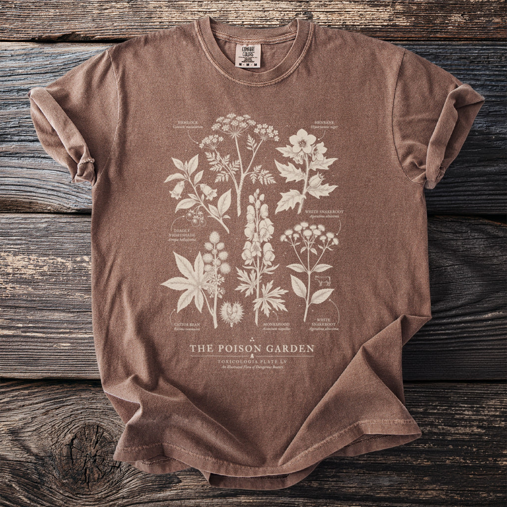 Brown t-shirt with botanical illustration of poisonous plants and text "The Poison Garden".