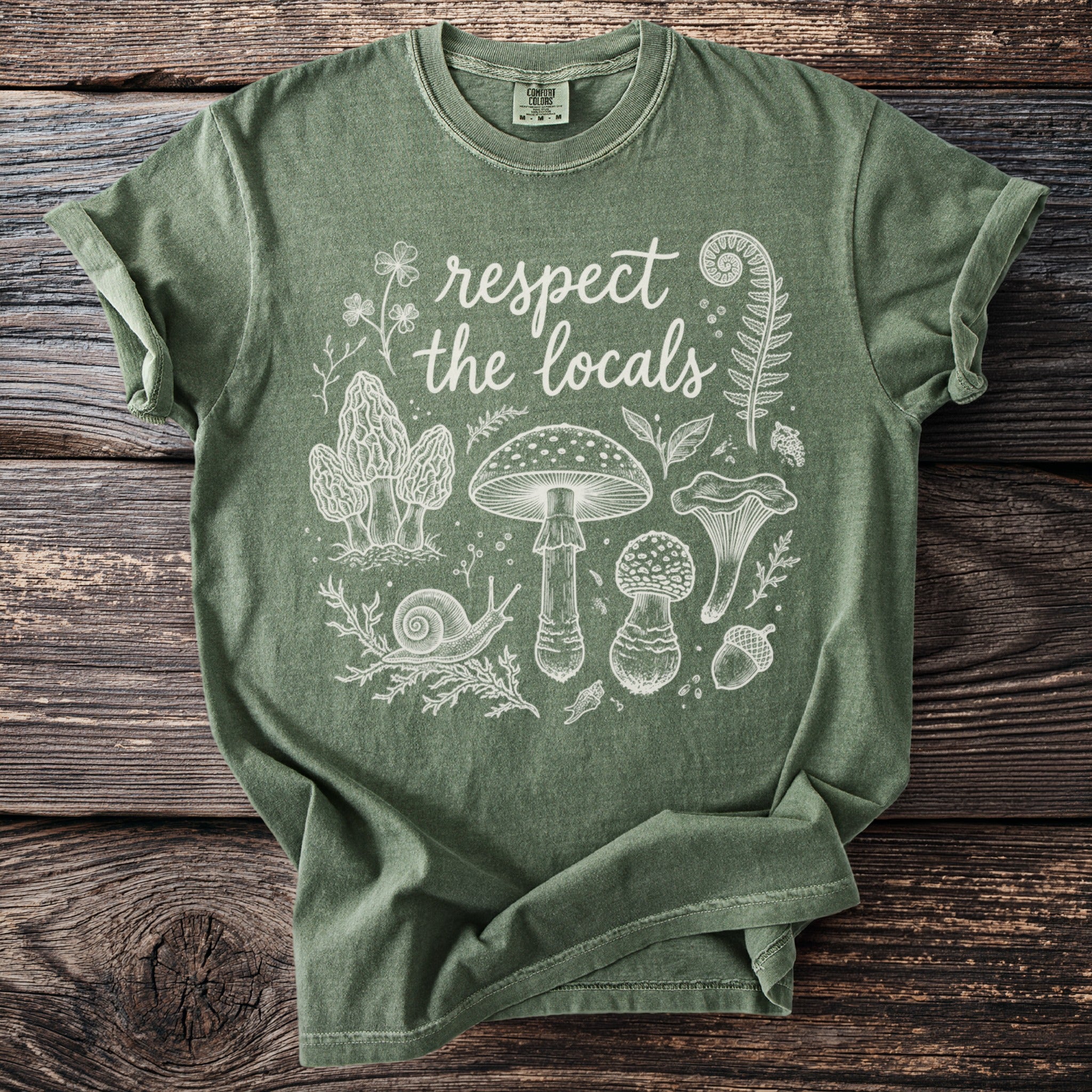 Green t-shirt with white "respect the locals" text and foraging illustrations.
