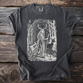 T-shirt graphic of a deer-antlered woman and deer in a forest scene.
