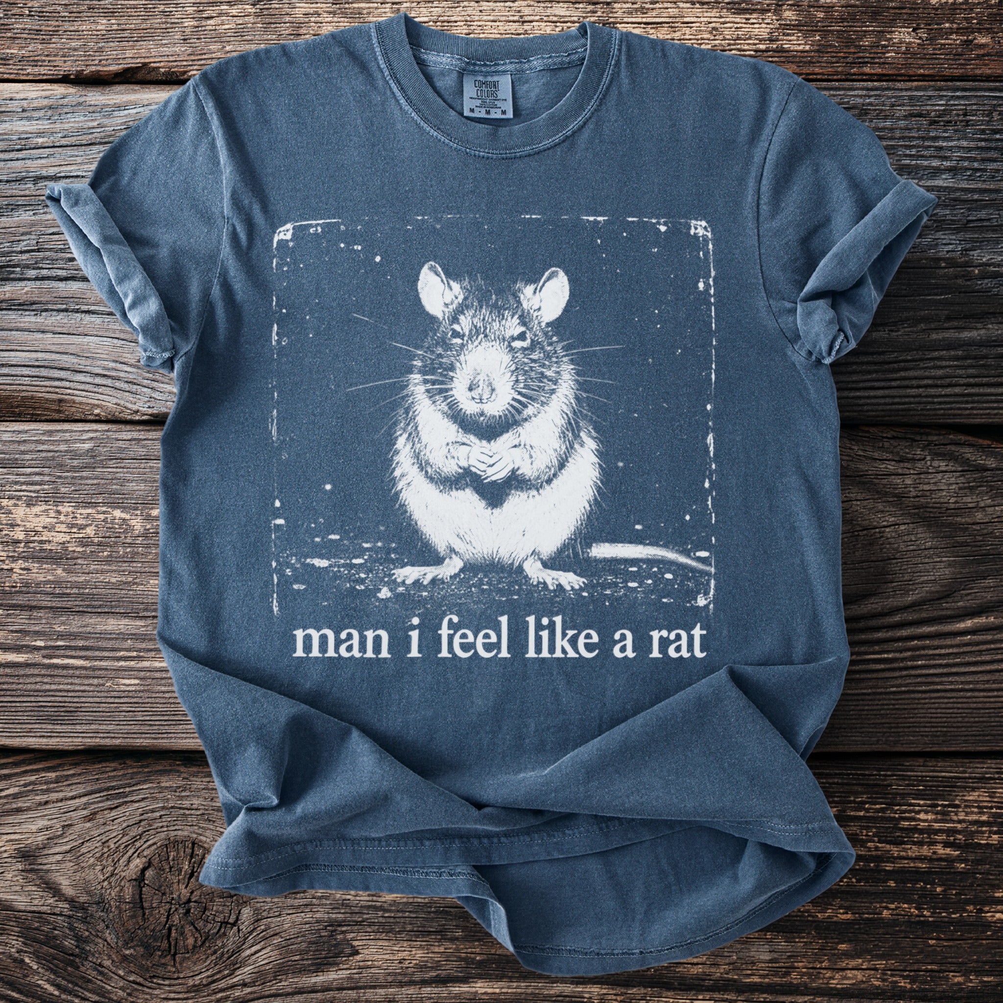 Blue t-shirt with a white graphic of a rat and the text "man i feel like a rat".