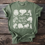 Green t-shirt with safari animals and "respect the locals" text design.
