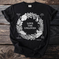 Black t-shirt with white circular design of marine life and text.