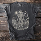 Dark grey t-shirt with a light-colored print of a woven figure surrounded by nature and figures.