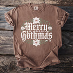 Brown t-shirt with "Merry Gothmas" graphic with skulls and poinsettias.