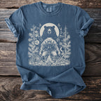 Blue t-shirt with graphic of a bear, a man in furs, and runes around a campfire.