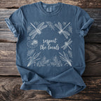 Blue t-shirt with white line art of dragonflies, lily pads, and cattails, featuring text "respect the locals".