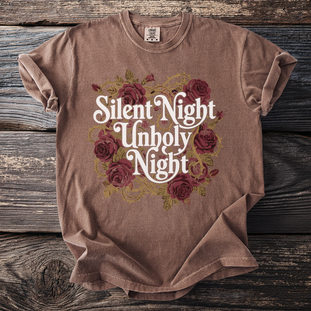Brown t-shirt with "Silent Night Unholy Night" text and rose bouquet design.