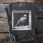 T-shirt with text "please do not perceive me" and a bird graphic.