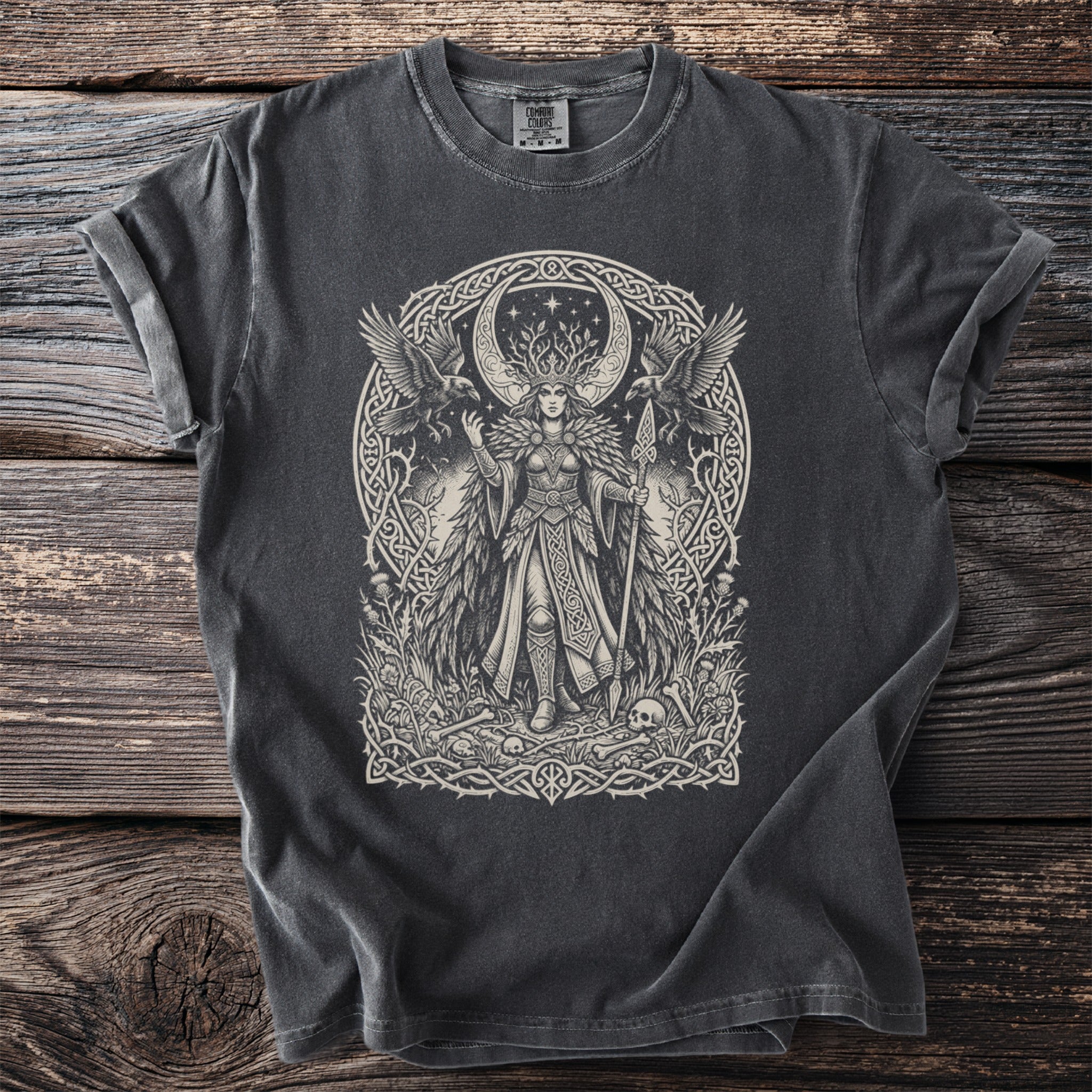 Dark t-shirt featuring a print of a Celtic goddess with ravens, moon, and skulls.
