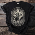Black t-shirt with an oval print of a figure with two ravens and woodland scene.