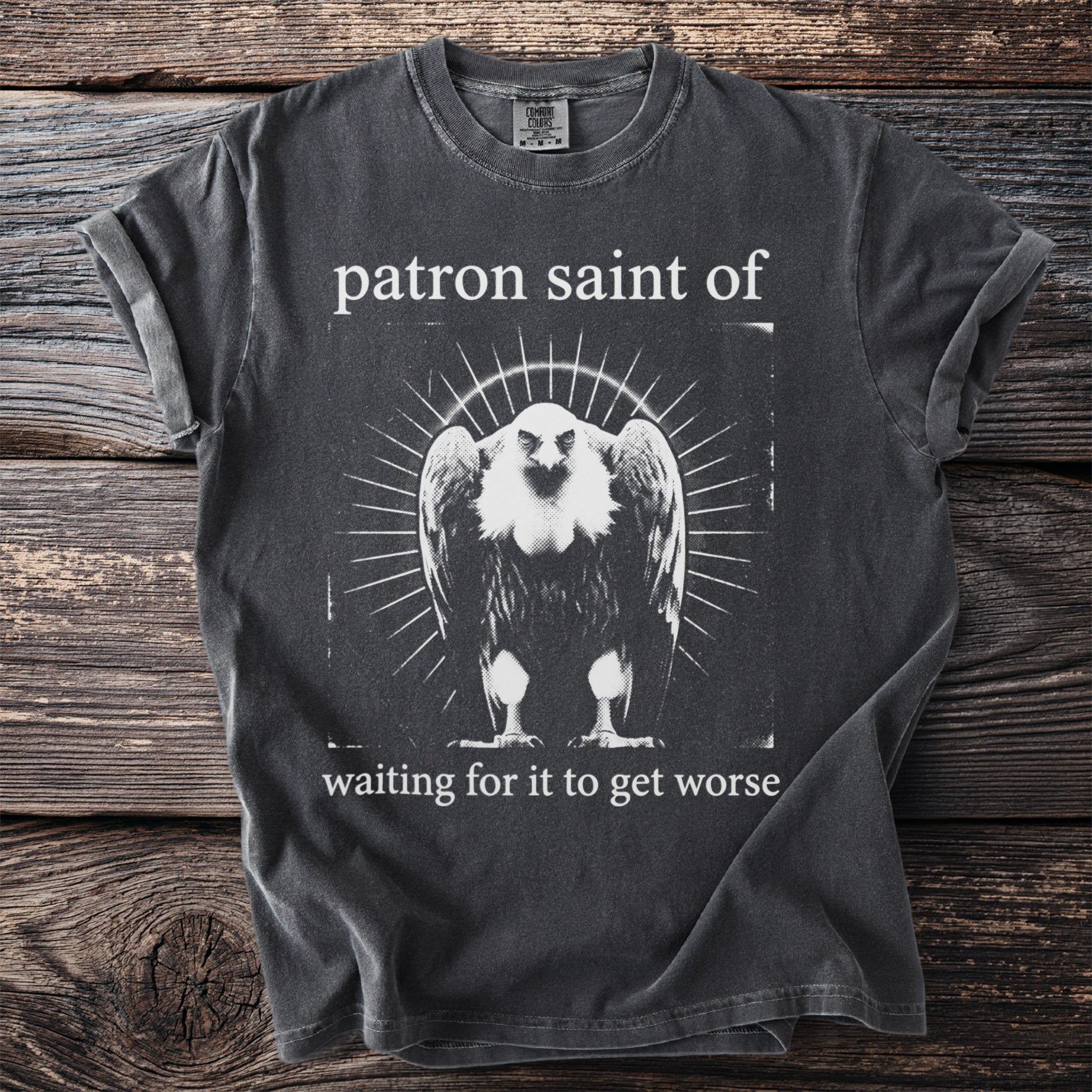 Dark grey t-shirt with graphic art of a vulture and text "patron saint of waiting for it to get worse".