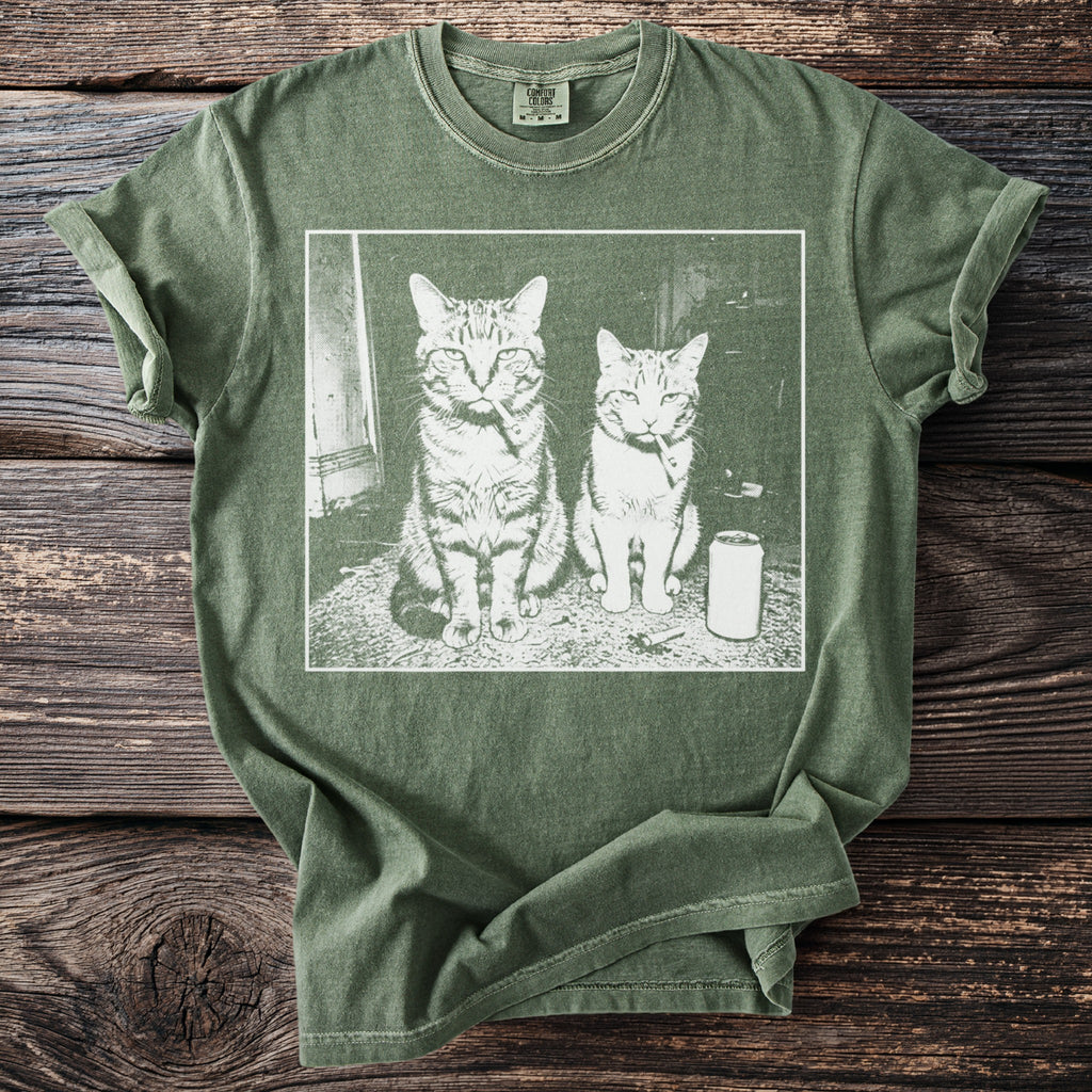 T-shirt with graphic of two cats sitting and smoking with a can of soda.