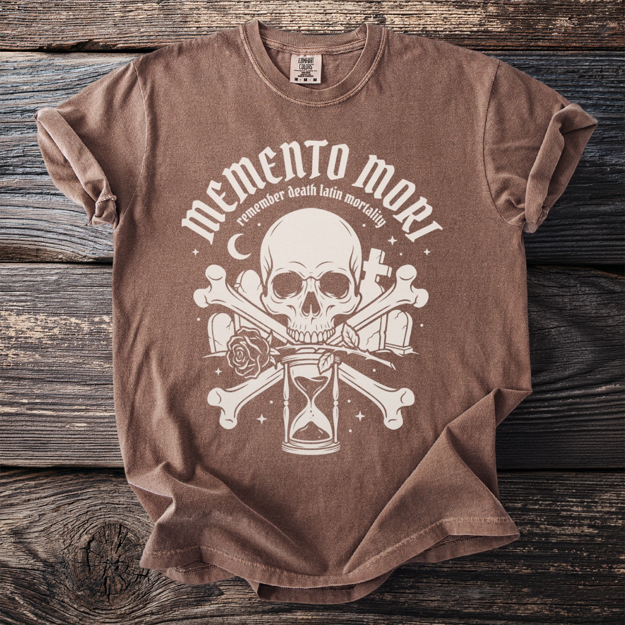 Brown t-shirt with "Memento Mori" graphic featuring a skull, hourglass, bones, and roses.