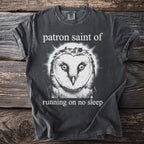 Dark t-shirt with an owl graphic and text "patron saint of running on no sleep".