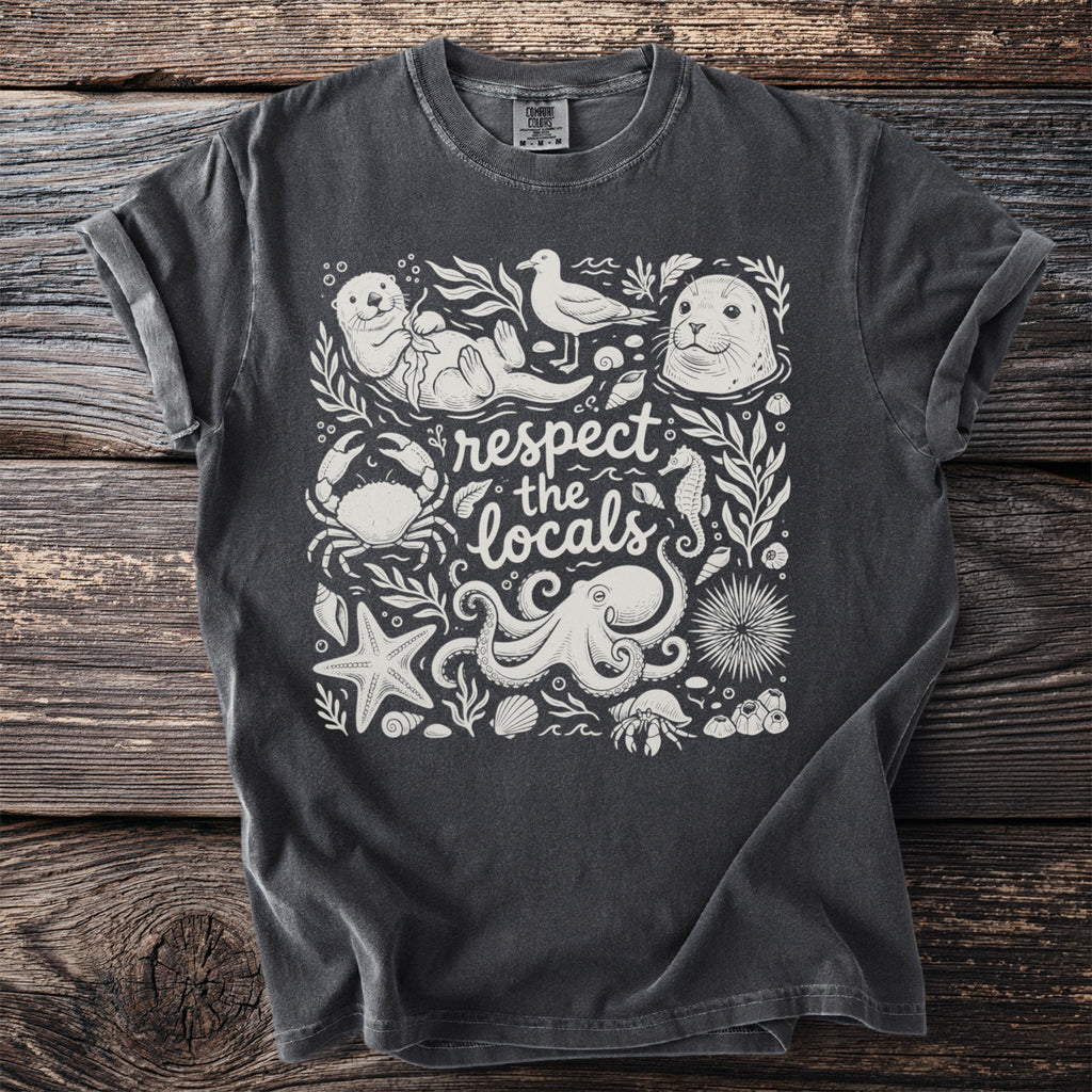 Dark t-shirt with white marine life illustration and text "respect the locals".
