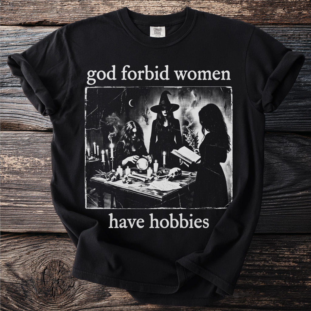 Black t-shirt with "god forbid women have hobbies" and image of three women.