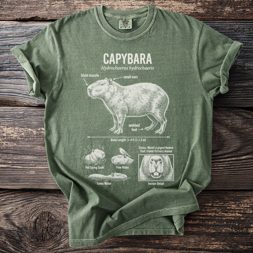 Green t-shirt with a diagram illustrating the capybara, its features and behaviors.