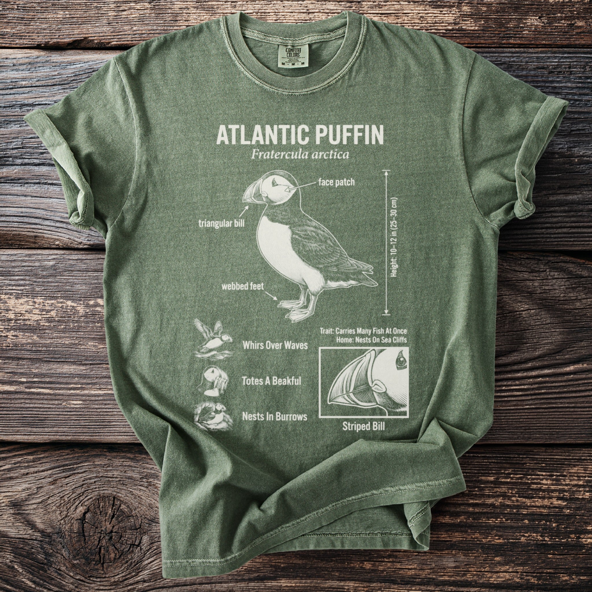 Green t-shirt with Atlantic Puffin diagram: triangular bill, face patch, webbed feet.