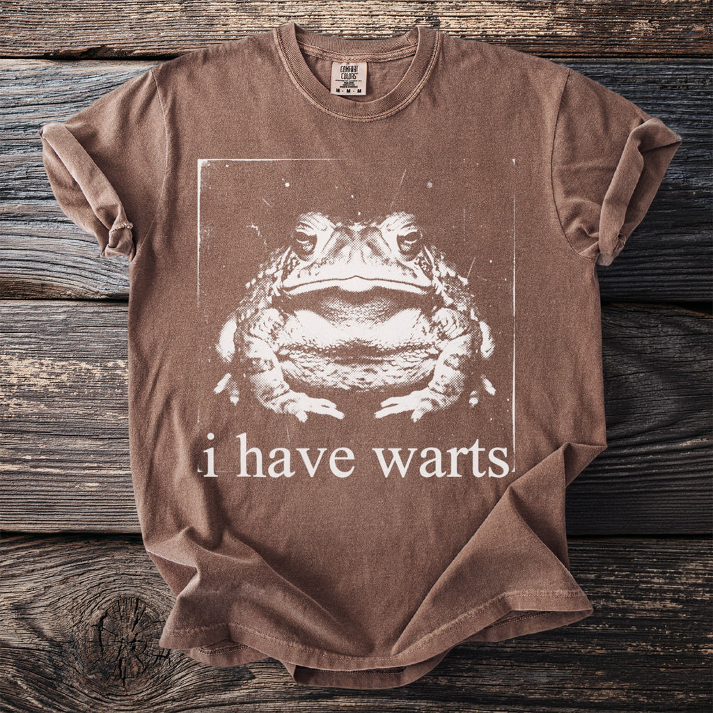 Brown t-shirt with a graphic of a toad and the text "i have warts."