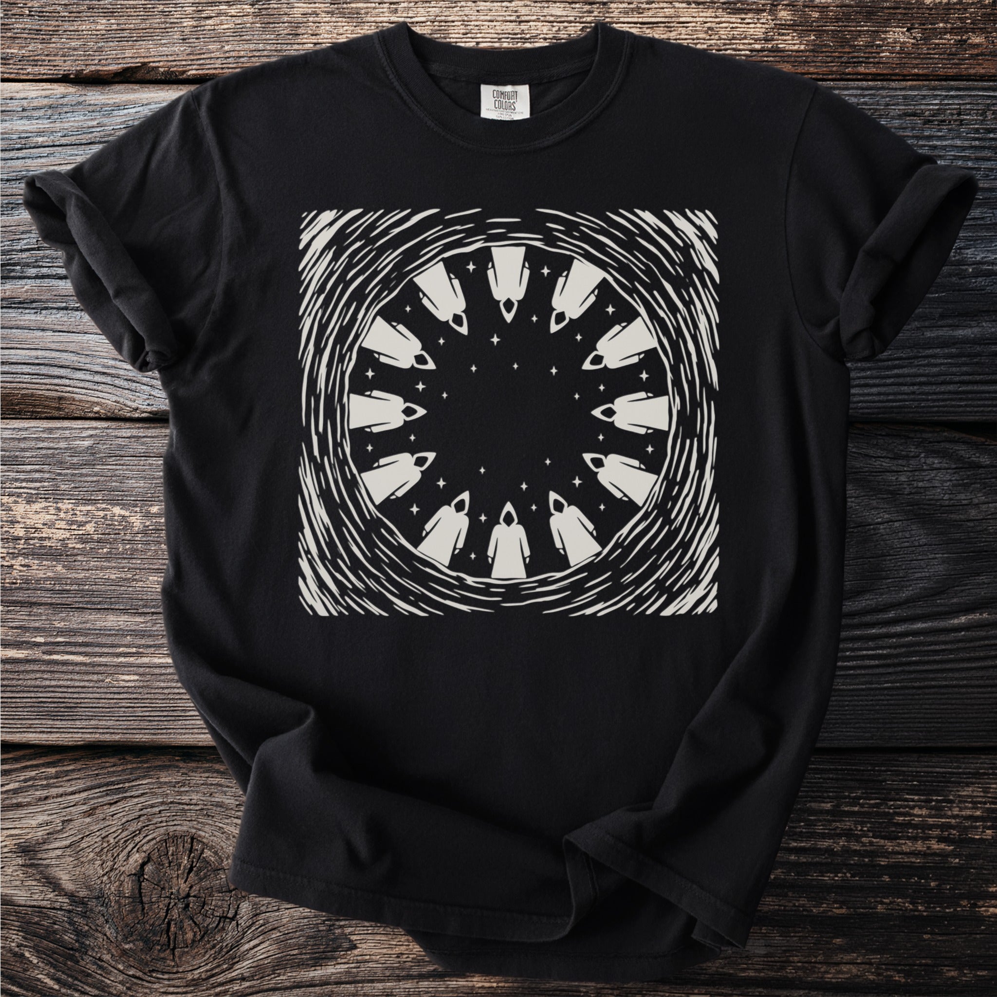 Black t-shirt with a circular design of hooded figures and stars.
