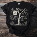 Black t-shirt with a vintage Halloween design of a tree, moon, bats, and lantern.