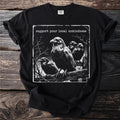 Black t-shirt with a graphic of ravens on a branch and text "Support your local unkindness."