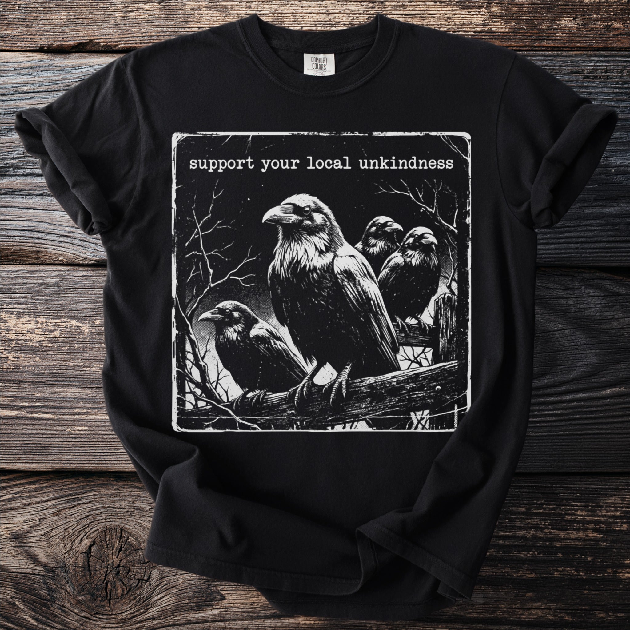 Black t-shirt with a graphic of ravens on a branch and text "Support your local unkindness."