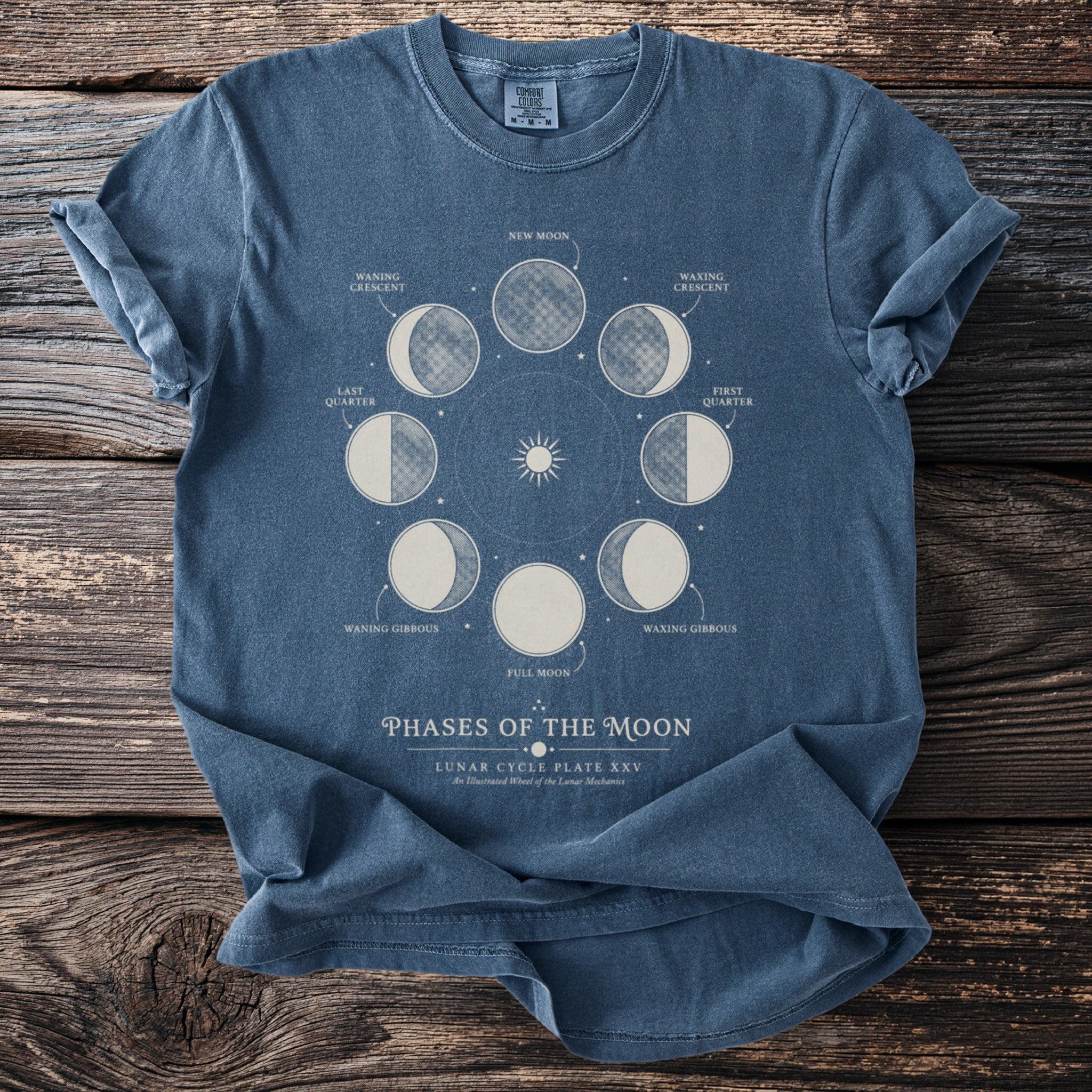 T-shirt with phases of the moon and stars graphic.