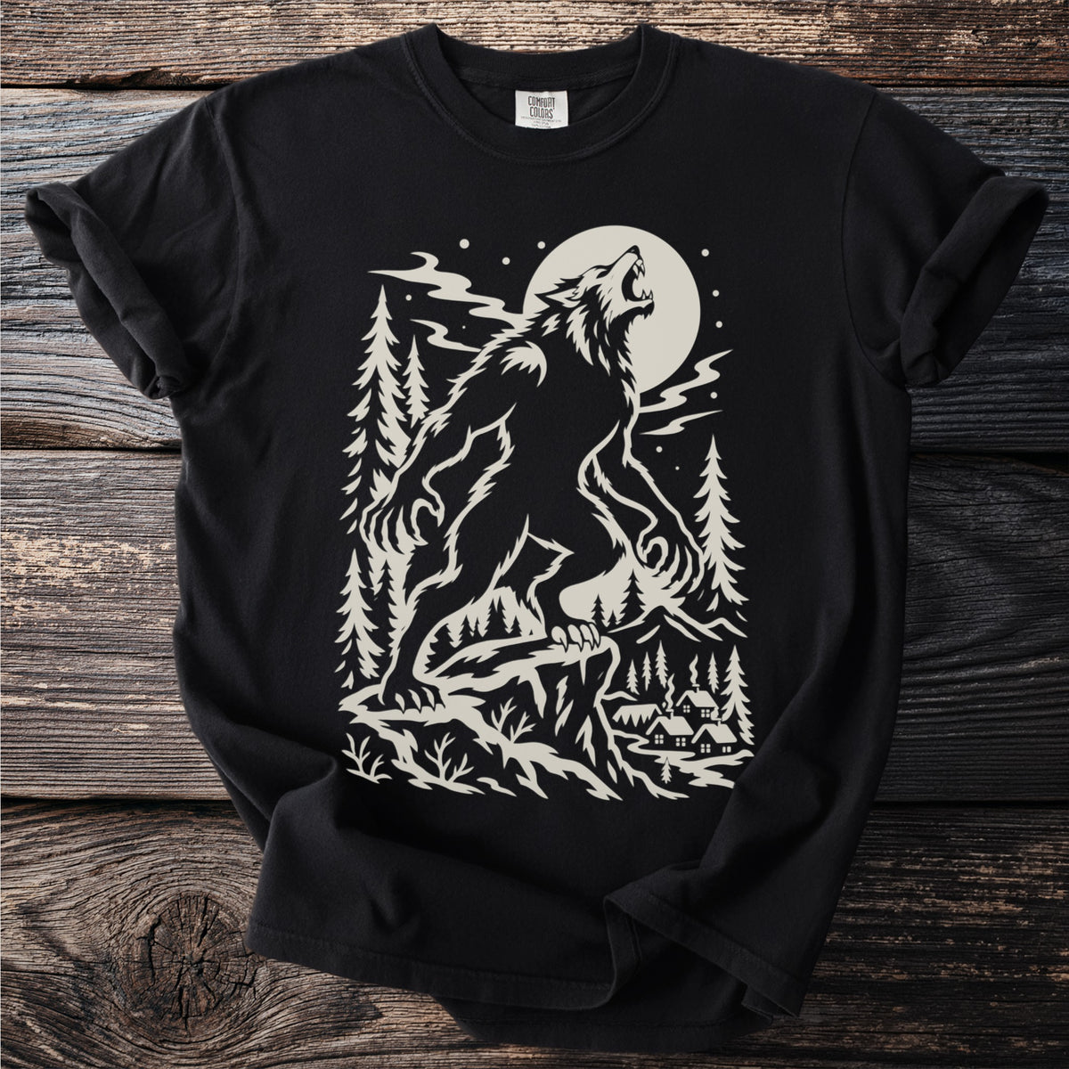 Werewolf howling at full moon over forest village, Comfort Colors shirt.
