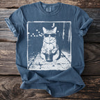 Blue t-shirt with a graphic of a cat wearing sunglasses and drinking an iced beverage.