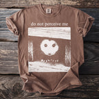Brown t-shirt graphic of a possum peeking out of a box, with text "do not perceive me".