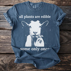T-shirt with white goat eating greens and text "all plants are edible some only once".