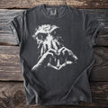 Dark grey t-shirt with a white graphic of a tentacled face and hands forming a heart around a lighthouse.