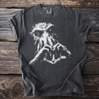 Dark t-shirt with white graphic of Cthulhu's face and hands forming heart around a lighthouse.