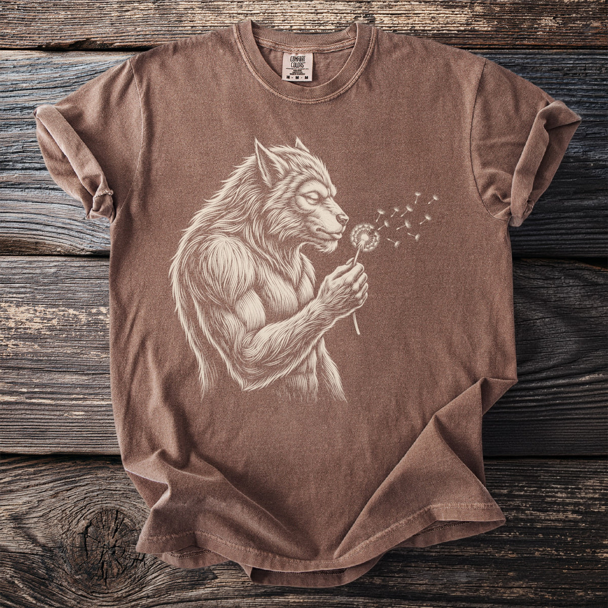Brown t-shirt with a detailed drawing of a werewolf blowing on a dandelion.