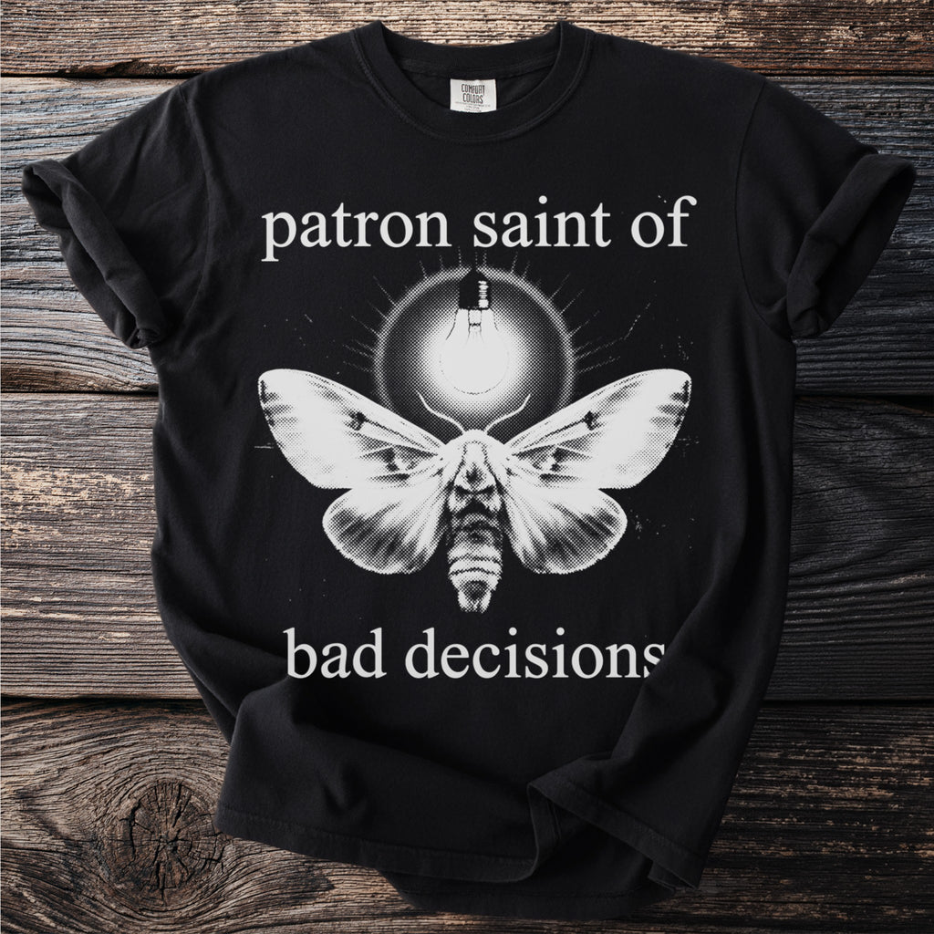 Black t-shirt with moth and lightbulb graphic reading "patron saint of bad decisions".