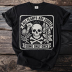 Black t-shirt with skull, crossbones, plants, and text.