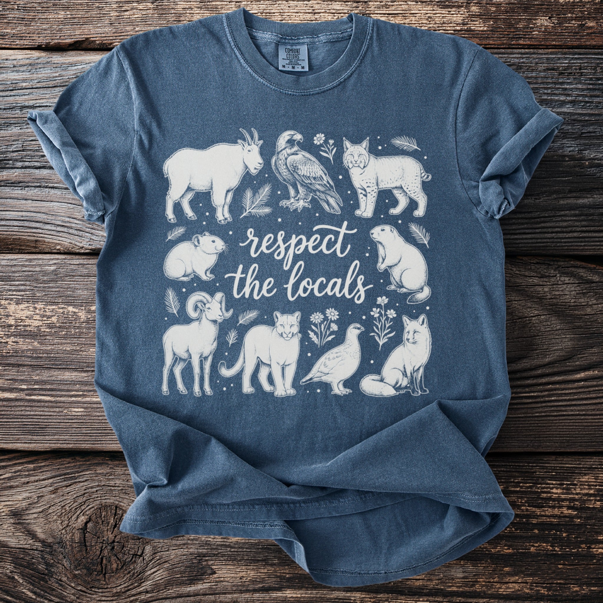 Blue t-shirt with a Wildlife illustration and "respect the locals" text.