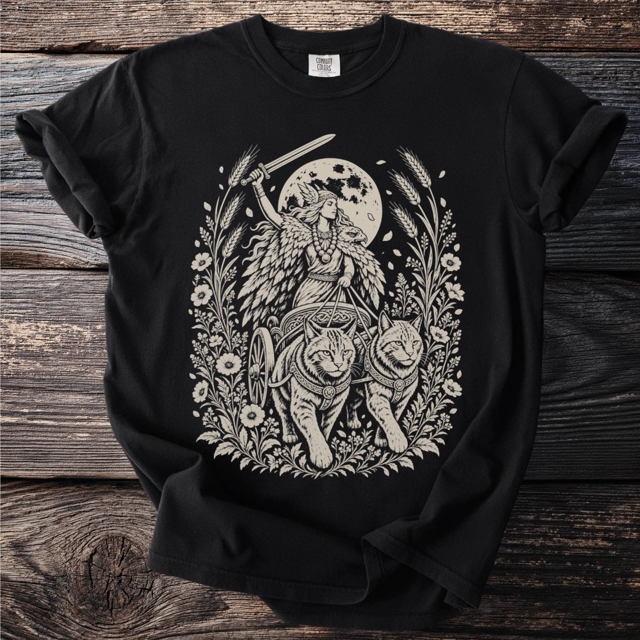 Black t-shirt featuring intricate Norse goddess Freya riding cats, with a moon and foliage design.