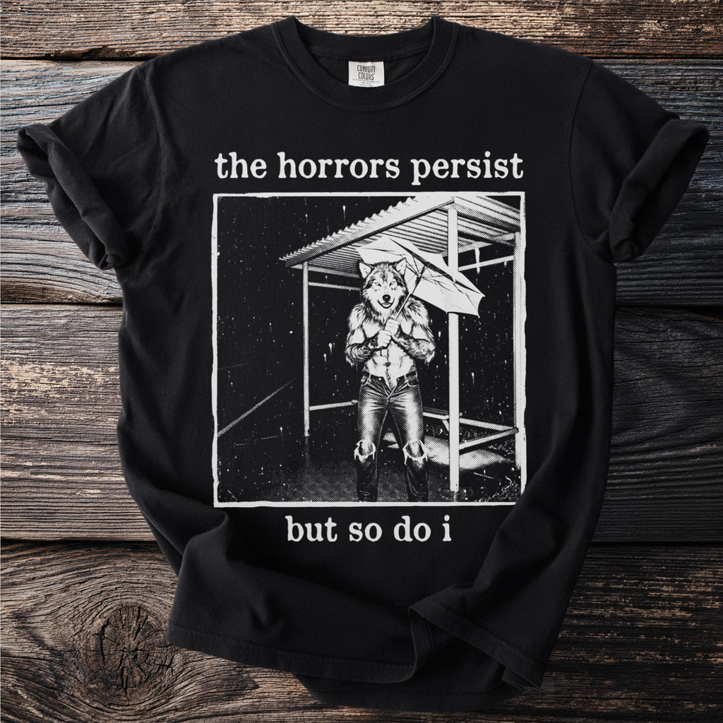 Black t-shirt with "the horrors persist but so do i" text and wolf graphic.
