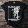 Black t-shirt with "the horrors persist but so do i" text and wolf graphic.