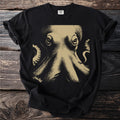 Black t-shirt with a close-up gold-toned octopus graphic and Comfort Colors tag.