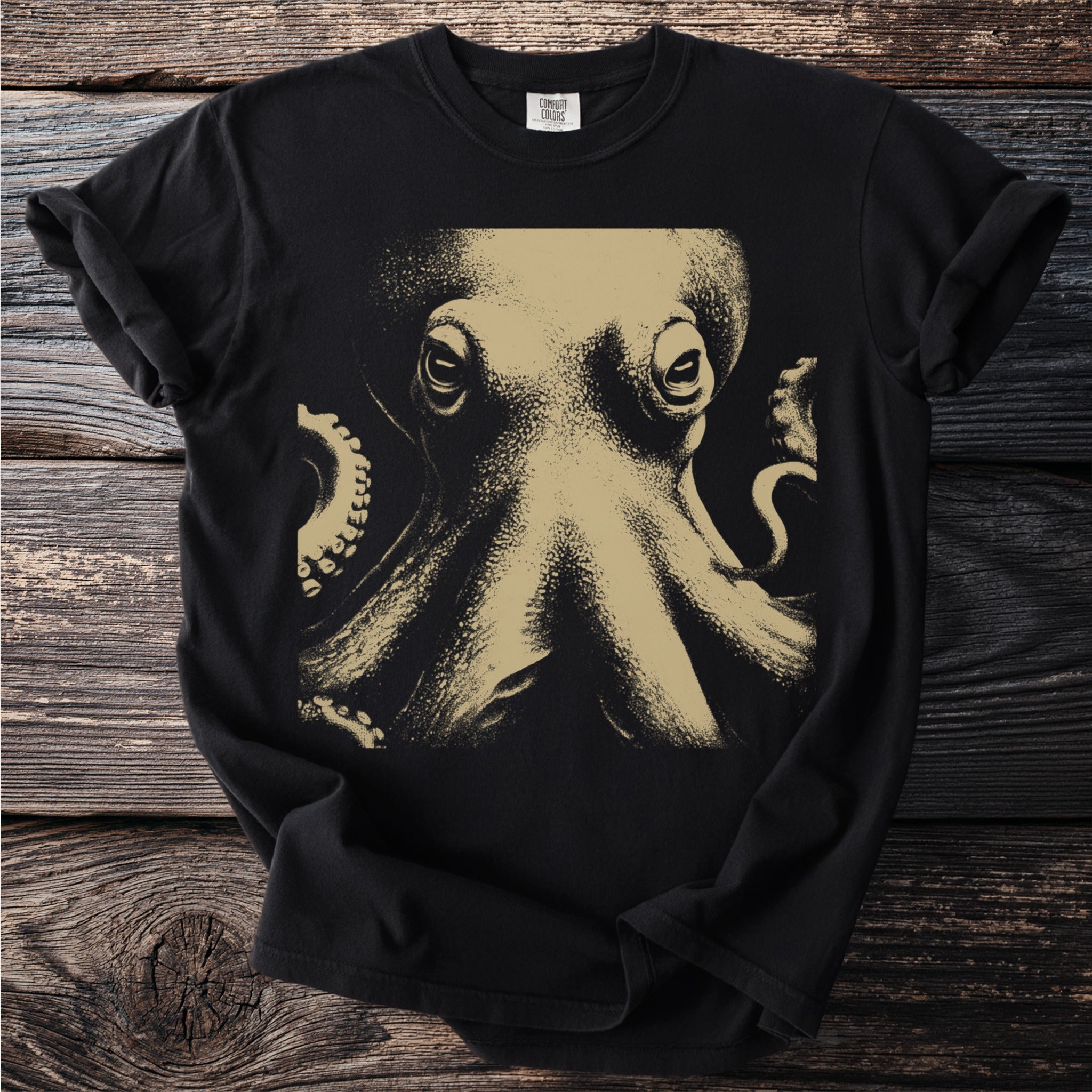 Black t-shirt with a close-up gold-toned octopus graphic and Comfort Colors tag.
