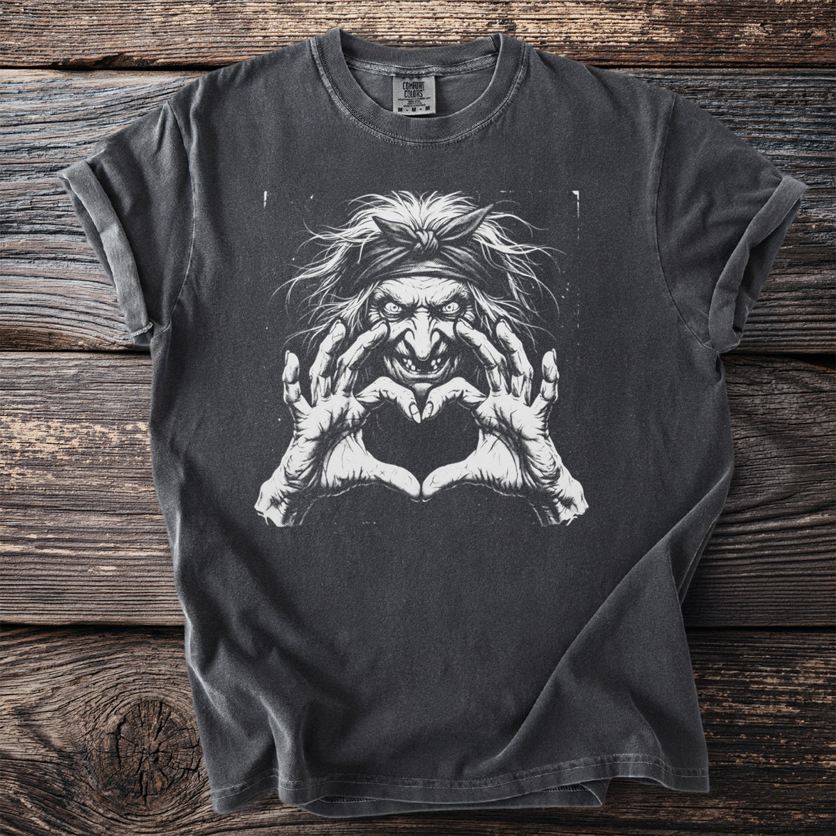 Dark grey t-shirt with a white graphic of a witch making a heart shape with her hands.