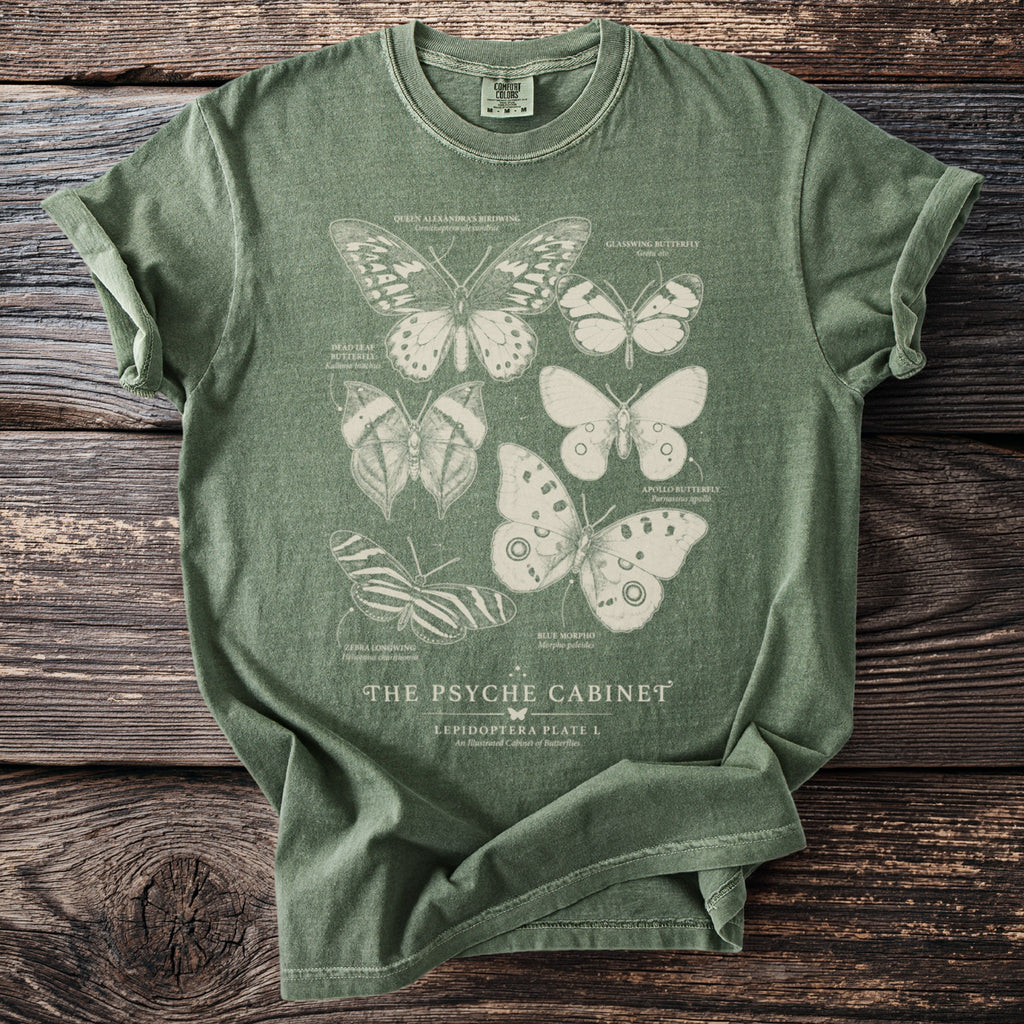 Green t-shirt featuring illustrated butterflies and the text "The Psyche Cabinet".