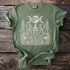 Green t-shirt with celestial triple moon, three maidens, and deer graphic illustration.